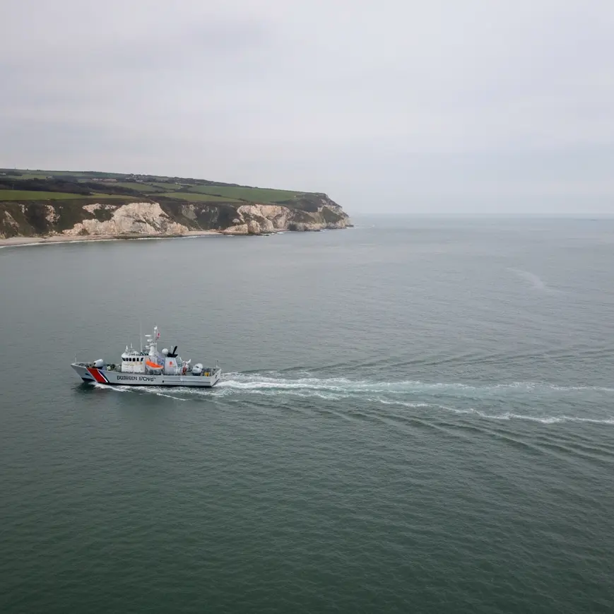 Aerial view of the English Channel near Dover with a UK Border Force patrol vessel, illustrating small boat crossing activity monitored by the Home Office
